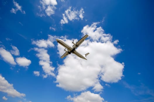 Plane on a blue and cloudy sky