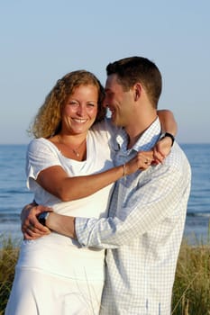 A happy woman and man in love at beach.