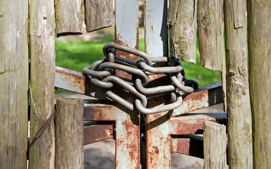 wooden fence protected, closed with chains