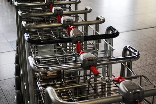 A row of trolleys at an airport.