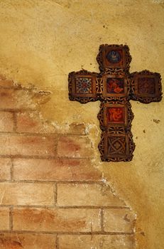 Broken brick wall with a Celtic cross.
