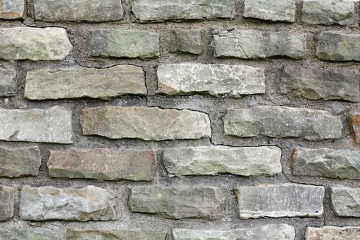 A gray brick wall background with mortar.
