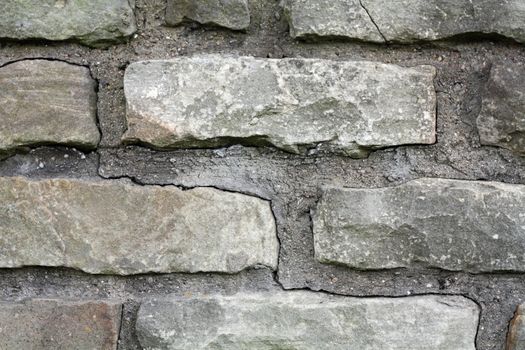 A gray brick wall background with mortar.
