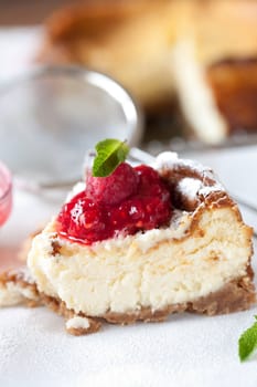 Delicious cheesecake with raspberry coulis and mint on top