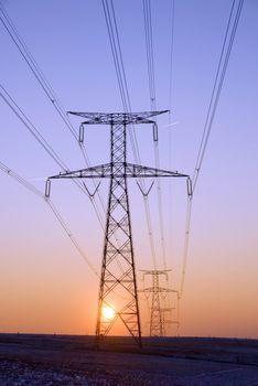line of pylons on sunset background