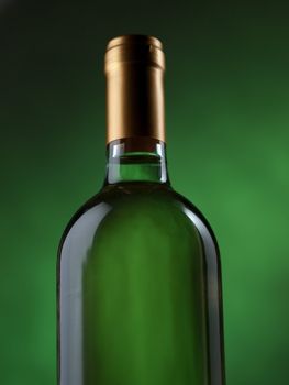 Bottle of white wine on green background