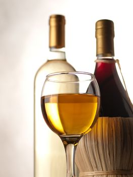 Bottles of white and red wine with wineglass