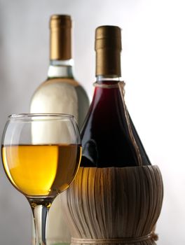 Bottles of white and red wine with wineglass