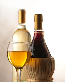 Bottles of white and red wine with wineglass