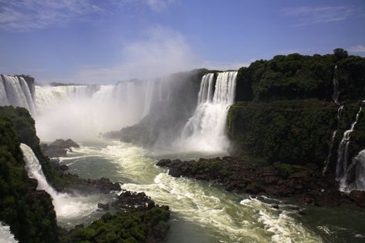 The Iguassu (or Iguazu) Falls is one of the largest masses of fresh water on the planet and divides, in South America, Brazil, Paraguay and Argentina. The waterfall system consists of 275 falls along 2.7 kilometres (1.67 miles) of the Iguazu River. Some of the individual falls are up to 82 metres (269 feet) in height, though the majority are about 64 metres (210 feet).