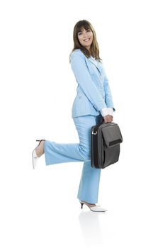 Business active woman standing over a white background with a briefcase in her arms