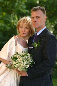 The groom and the bride in park