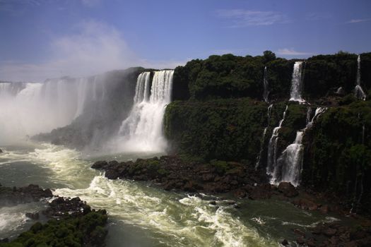 The Iguassu (or Iguazu) Falls is one of the largest masses of fresh water on the planet and divides, in South America, Brazil, Paraguay and Argentina. The waterfall system consists of 275 falls along 2.7 kilometres (1.67 miles) of the Iguazu River. Some of the individual falls are up to 82 metres (269 feet) in height, though the majority are about 64 metres (210 feet).