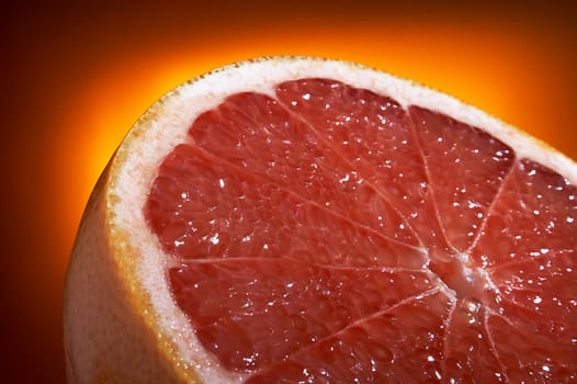 Half of grapefruit on a orange background