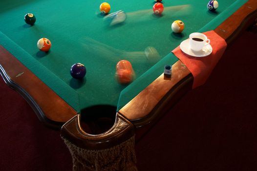 White cup from coffee on a billiard table