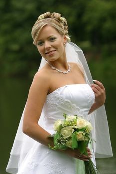 The beautiful bride with a bouquet from roses