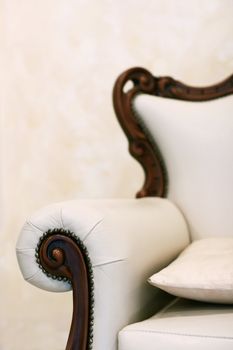 Beautiful white leather armchair with a pillow