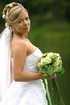 Portrait of the beautiful bride with a bouquet