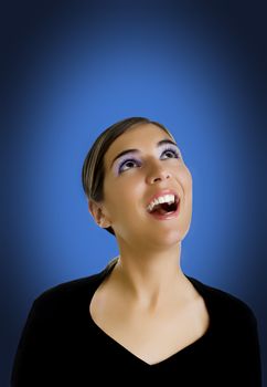 Beautiful woman portrait looking to the top on a blue background