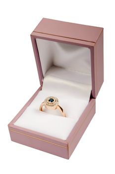 Precious ring in a pink box on a white background