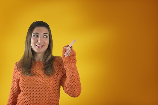 Beautiful woman with a frendly face on a orange background