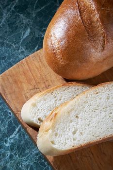 Chunks of a white loaf on a kitchen table