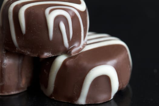 Closeup of chocolates on black background