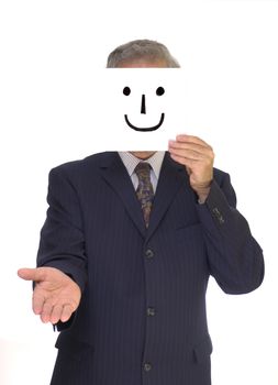 A pinstripe-suited businessman hold out his hand for a handshake with a home-made smiley mask in front of his face.