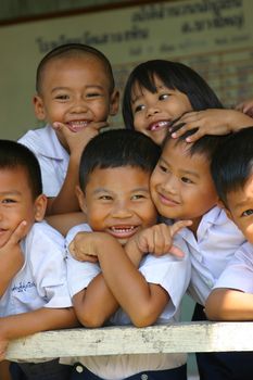 Adorable schoolchildren having fun with the photographer