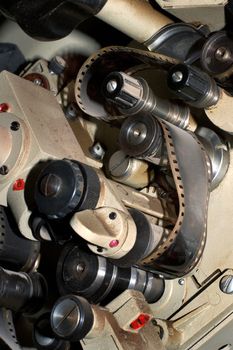 Fragment of an old film projector with a film