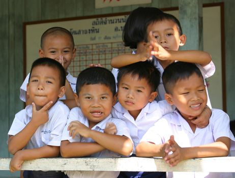 Adorable schoolchildren having fun with the photographer