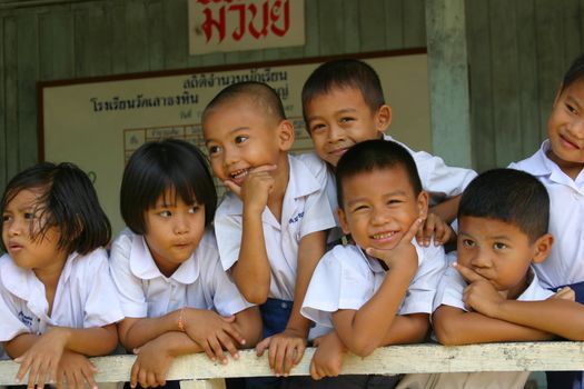 Adorable schoolchildren having fun with the photographer