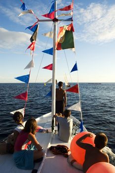 Kids on a deck of a decorated boat