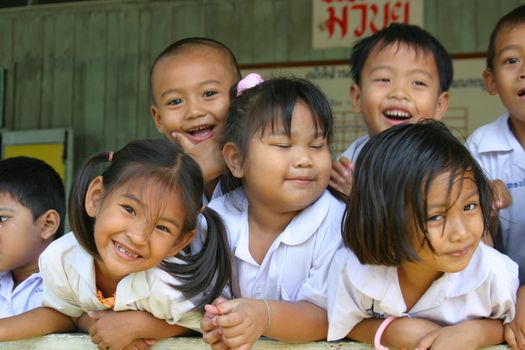 Adorable schoolchildren having fun with the photographer