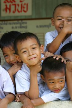 Adorable schoolchildren having fun with the photographer