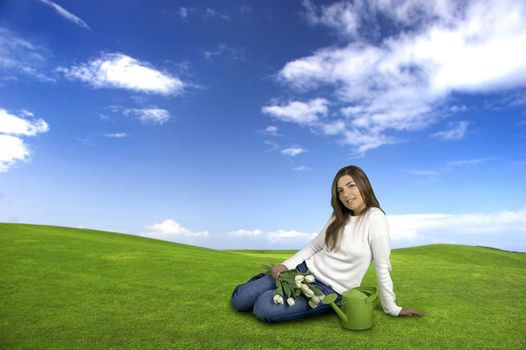 Beautiful young woman on a green landscape with tulips