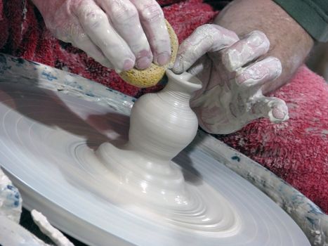 A potter artistically creates a vessel to be decorated and used.