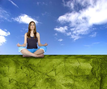 Beautiful athletic woman making yoga on a green wall 