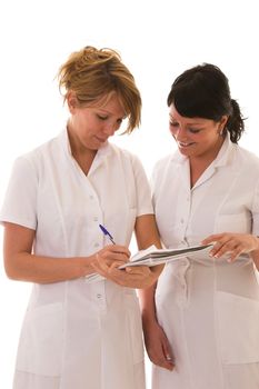 Two young nurses compairing notes