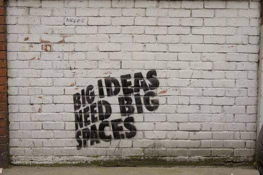'Big ideas need big spaces' graffiti on a wall