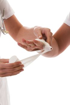 Nurse wrapping an injured hand in a bandage