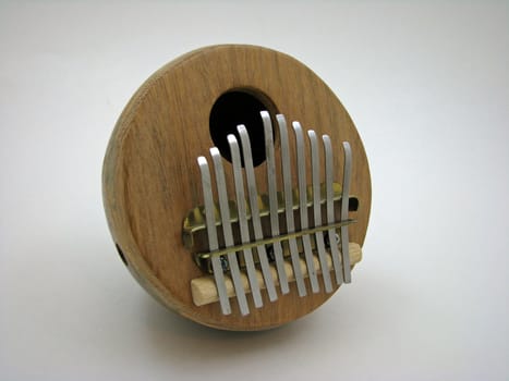 An African gourd thumb piano on white background. 