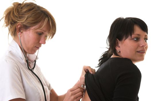 Nurse lifting the shirt of her patient to listen to her lungs