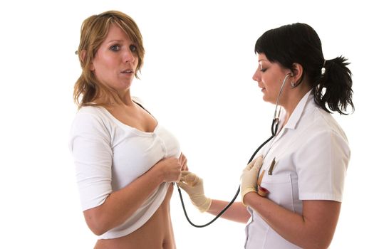Blond woman holding her breath in while the nurse is listening through her stethoscope