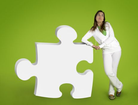 Woman contemplating questions with 3D puzzle form on a green background