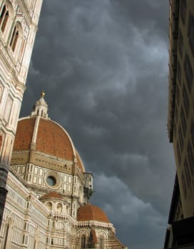 Afternoon storm clouds gather over the Duomo in Florence, Italy. The orange dome of the Duomo was an architectural masterpiece designed by the architect Brunelleschi. 