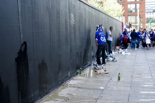 Rangers fan urinating on a wall near Piccadilly gardens