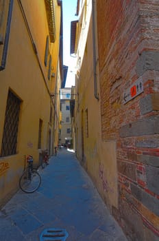 Narrow Alley With Old Buildings In Italian City of Lucca