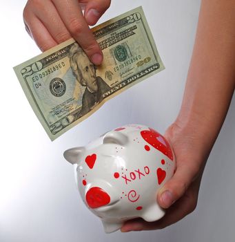kid hands with piggy bank on white background
