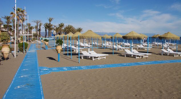 sunbeds and parasols on a sandy beach